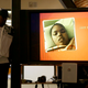 A recent photo of Jahi McMath is shown on a video screen next to her uncle Timothy Whisenton at a news conference in San Francisco on Dec. 23, 2015. (Jeff Chiu/AP)